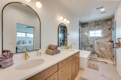 a bathroom with two sinks and a large mirror at 13 Mi to Boulder Family-Friendly Home in Erie! in Erie