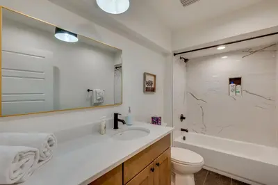 a bathroom with a sink and a toilet and a tub at 13 Mi to Boulder Family-Friendly Home in Erie! in Erie