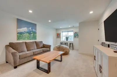 a living room with a couch and a table at 13 Mi to Boulder Family-Friendly Home in Erie! in Erie