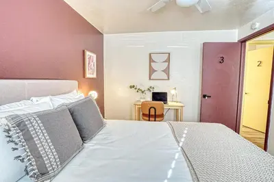 a bedroom with a bed and a table with a chair at Joy House in Golden