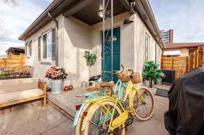 a yellow bike parked in front of a house at Boho Cozy House with bikes, 2 blocks to Sloans Lake! in Denver