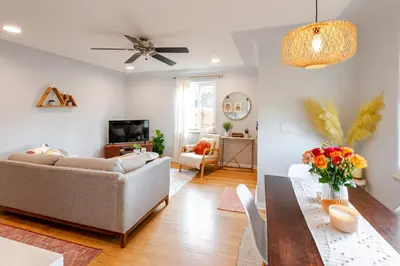 a living room with a couch and a table at Boho Cozy House with bikes, 2 blocks to Sloans Lake! in Denver