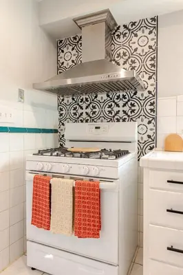 a kitchen with a white stove with towels on it at Boho Cozy House with bikes, 2 blocks to Sloans Lake! in Denver