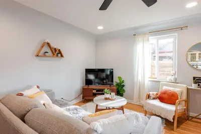 a living room with a couch and a tv at Boho Cozy House with bikes, 2 blocks to Sloans Lake! in Denver