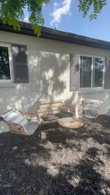 three chairs and a table in front of a house at Boho Cozy House with bikes, 2 blocks to Sloans Lake! in Denver