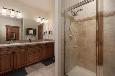 a bathroom with two sinks and a shower at 19th Hole cabin in Granby
