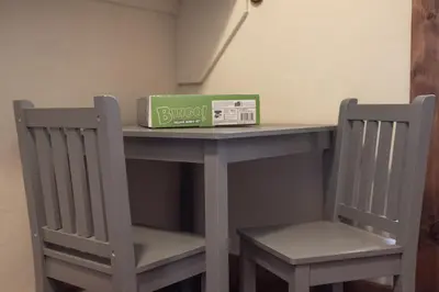 a table and two chairs with a box on it at 19th Hole cabin in Granby
