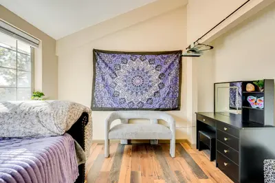 a bedroom with a bed and a desk and a rug at 3 Mi to Casinos Cabin with Stables in Black Hawk! in Black Hawk