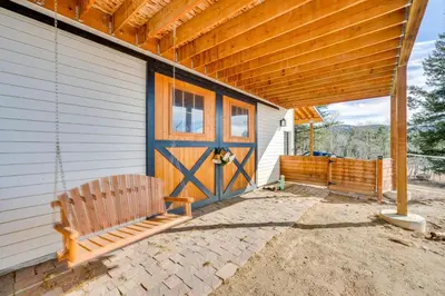 a house with a porch with a wooden door at 3 Mi to Casinos Cabin with Stables in Black Hawk! in Black Hawk