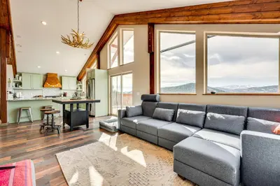 a living room with a couch and large windows at 3 Mi to Casinos Cabin with Stables in Black Hawk! in Black Hawk