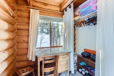a desk in a log cabin with a window at Valley View Vistas lodge in Nederland