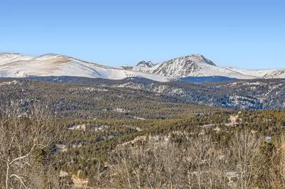 a view of a mountain range with snow covered mountains at Valley View Vistas lodge in Nederland