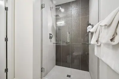 a shower with a glass door in a bathroom at Urban Elegance at Espadin in Denver