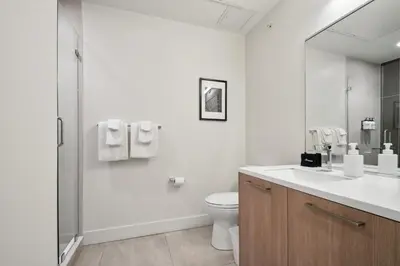 a white bathroom with a toilet and a shower at Urban Elegance at Espadin in Denver