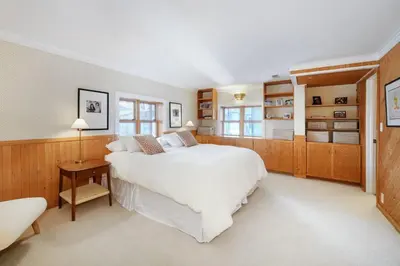 a bedroom with a large white bed and wooden cabinets at 5 minute drive to Pearl Street - Best Neighborhood in Boulder in Boulder