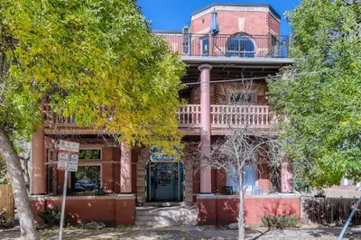 an old red brick house with a balcony at Cloud by Modern Midstay - 1 Block to City Park #C1 in Denver
