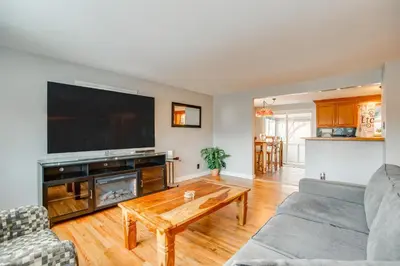 a living room with a large flat screen tv at 12 Mi to Dtwn Denver Home with Fenced Backyard! in Northglenn
