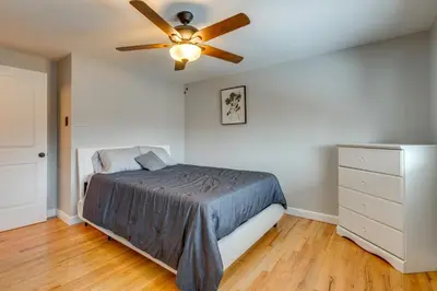 a bedroom with a bed and a ceiling fan at 12 Mi to Dtwn Denver Home with Fenced Backyard! in Northglenn