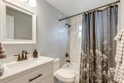 a bathroom with a sink toilet and a shower curtain at 12 Mi to Dtwn Denver Home with Fenced Backyard! in Northglenn