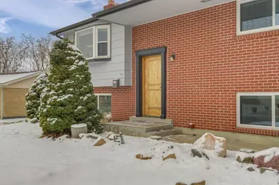 a house with a christmas tree in the snow at 12 Mi to Dtwn Denver Home with Fenced Backyard! in Northglenn