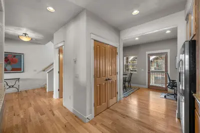 an empty living room with wood floors and a kitchen at 107 Red Quill in Winter Park
