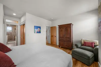 a bedroom with a large white bed and a chair at 107 Red Quill in Winter Park