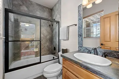a bathroom with a sink and a shower and a toilet at 107 Red Quill in Winter Park