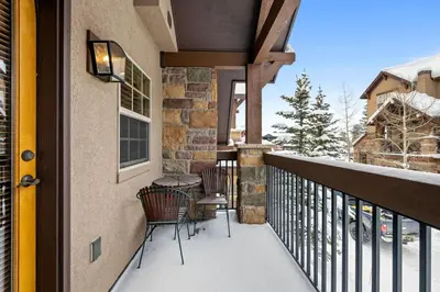 a balcony with two chairs and a table on it at 107 Red Quill in Winter Park
