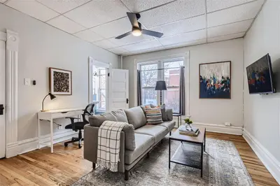 a living room with a couch and a desk at Cloud by Modern Midstay - 1 Block to City Park #C5 in Denver