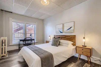 a bedroom with a bed and a desk and a window at Cloud by Modern Midstay - 1 Block to City Park #C5 in Denver