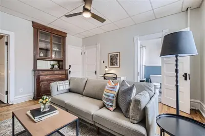 a living room with a couch and a table at Cloud by Modern Midstay - 1 Block to City Park #C5 in Denver