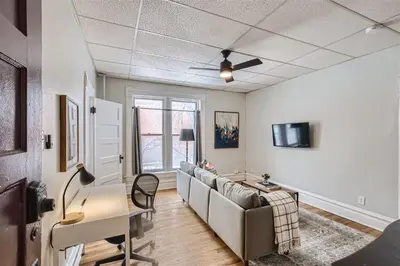 a living room with a couch and a table at Cloud by Modern Midstay - 1 Block to City Park #C5 in Denver