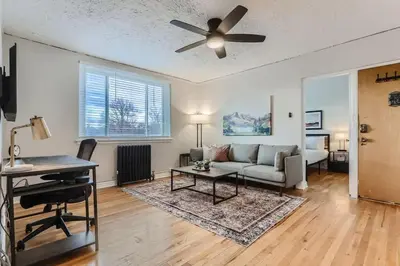 a living room with a couch and a ceiling fan at Detroit by Modern Midstay - On City Park #T22 in Denver