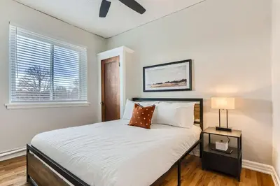 a bedroom with a large bed and a window at Detroit by Modern Midstay - On City Park #T22 in Denver