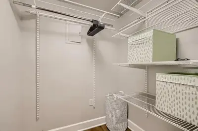 a walk in closet with white walls and shelves at Detroit by Modern Midstay - On City Park #T22 in Denver