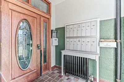 a room with a wooden door and a mirror at Detroit by Modern Midstay - On City Park #T22 in Denver