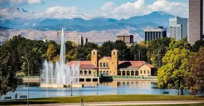 a building with a fountain in front of a city at Detroit by Modern Midstay - On City Park #T22 in Denver