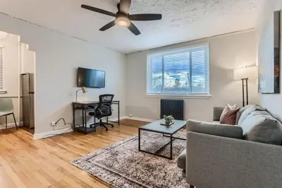 a living room with a couch and a table at Detroit by Modern Midstay - On City Park #T22 in Denver
