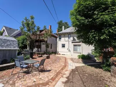 a patio with a table and chairs and a house at York by Modern Midstay - 3 Blocks to Cheesman #NYB in Denver
