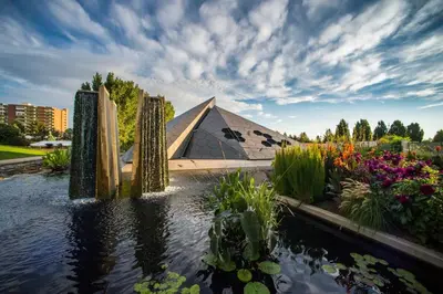a pyramidangular building with flowers in a garden at York by Modern Midstay - 3 Blocks to Cheesman #NYB in Denver