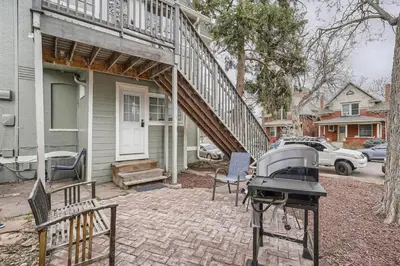 a house with a grill on a brick patio at 1st Ave by Modern Midstay - Wash Park & SoBo #F2 in Denver