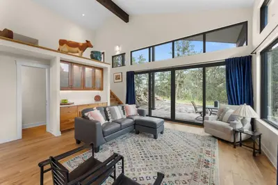 a living room with a couch and chairs and windows at Pineview Panorama Luxe Retreat 20 Mins to Boulder in Jamestown