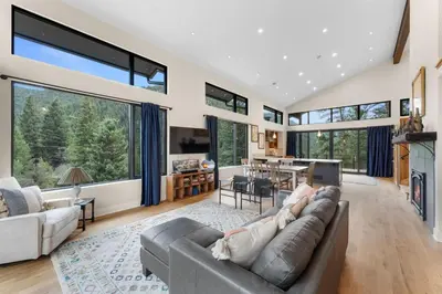 a living room with a couch and a table at Pineview Panorama Luxe Retreat 20 Mins to Boulder in Jamestown