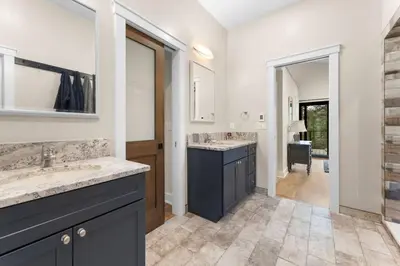 a bathroom with two sinks and a large mirror at Pineview Panorama Luxe Retreat 20 Mins to Boulder in Jamestown