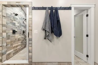 a pivot door in a bathroom with a mirror at Pineview Panorama Luxe Retreat 20 Mins to Boulder in Jamestown