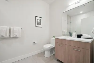 a bathroom with a toilet and a sink and a mirror at Cloud Nine Retreat at Espadin in Denver