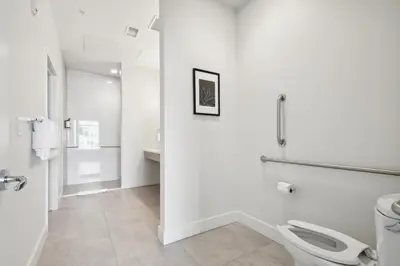 a white bathroom with a toilet and a sink at Cloud Nine Retreat at Espadin in Denver