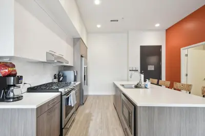a kitchen with a sink and a stove top oven at Cloud Nine Retreat at Espadin in Denver