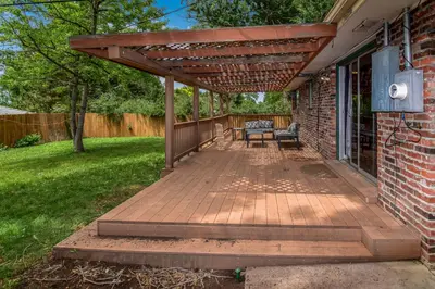 a wooden deck with a pergola on a house at Super Cute Five Bedroom Home in Denver Perfect For Girls Trips in Denver