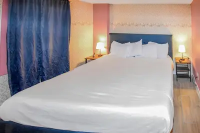 a large white bed in a hotel room at Super Cute Five Bedroom Home in Denver Perfect For Girls Trips in Denver